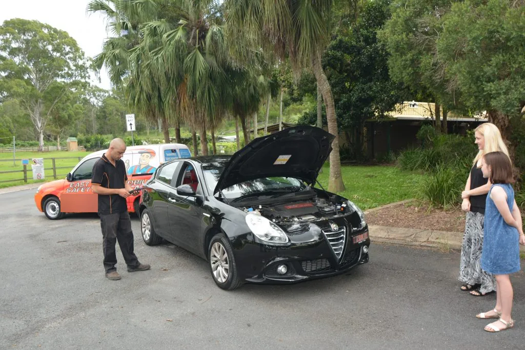 East Coast inspector checking a car with its owners